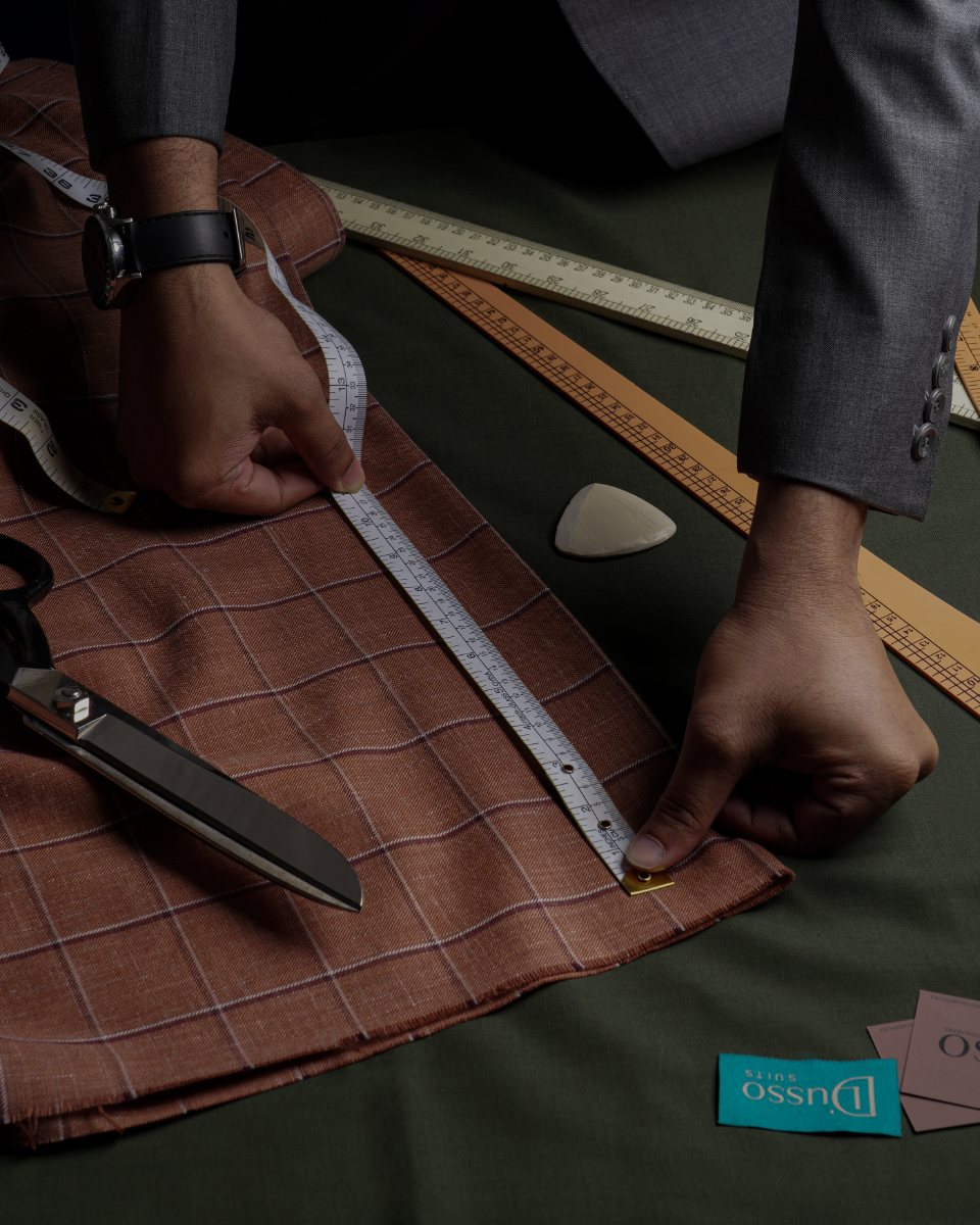 Cutting table — measuring windowpane cloth with shears and chalk